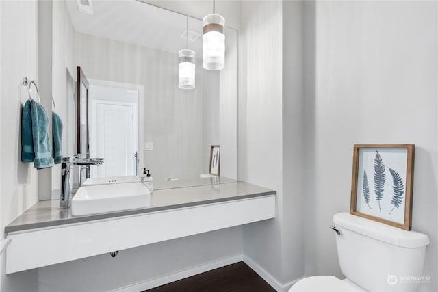 bathroom featuring toilet and vanity