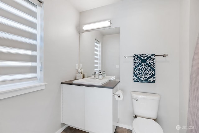 bathroom featuring vanity and toilet