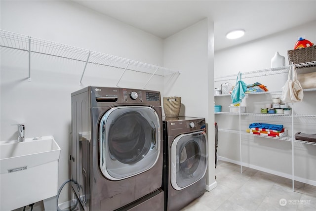 laundry area featuring sink and washer and clothes dryer