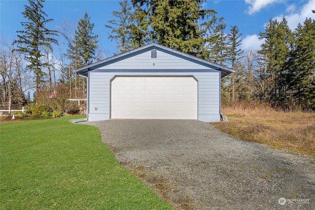 garage featuring a lawn