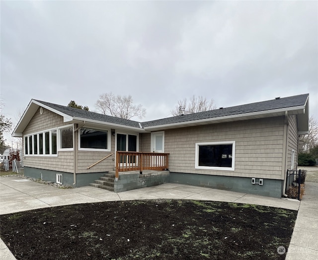 single story home featuring a wooden deck