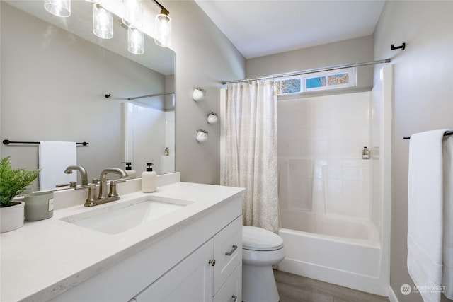 full bathroom with vanity, shower / bath combo, and toilet