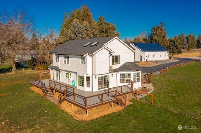 rear view of property featuring a yard and a sunroom