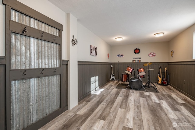 interior space featuring light hardwood / wood-style flooring and a textured ceiling