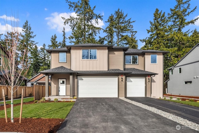 view of front of property with a garage and a front lawn