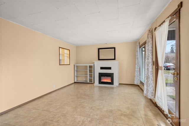 unfurnished living room with a brick fireplace