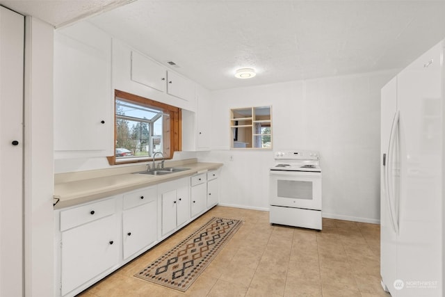 kitchen featuring sink, white appliances, plenty of natural light, and white cabinets