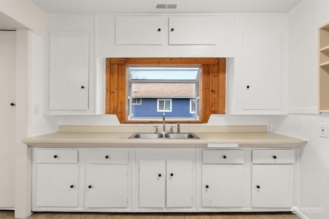 kitchen featuring sink and white cabinets