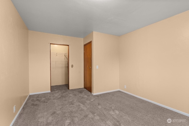 unfurnished bedroom featuring light colored carpet and a closet