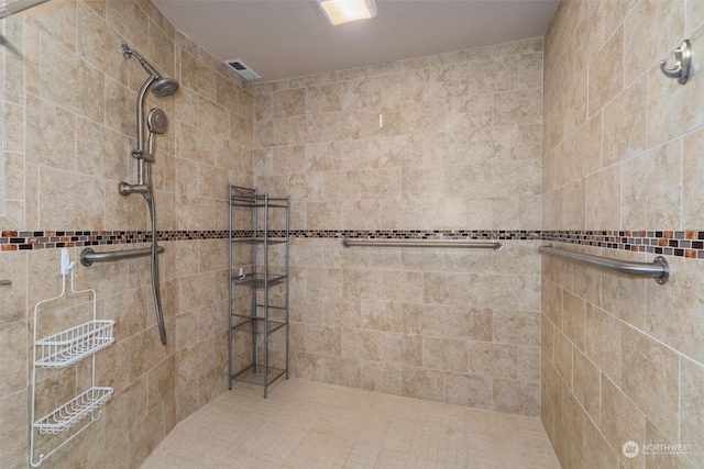 bathroom with a tile shower