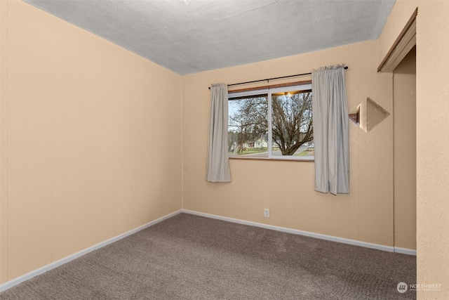 carpeted empty room with a textured ceiling