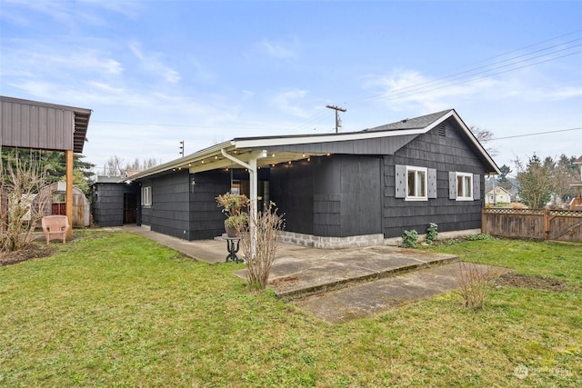 back of property with a patio and a lawn