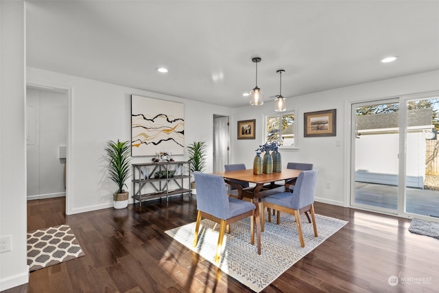 dining space with dark hardwood / wood-style floors