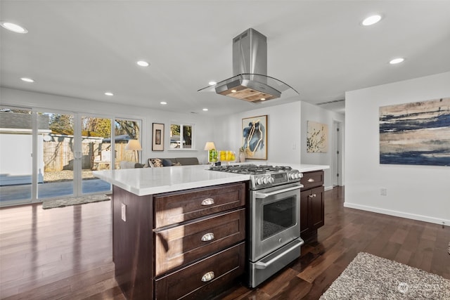 kitchen with gas stove, a kitchen island, dark hardwood / wood-style flooring, island range hood, and dark brown cabinets