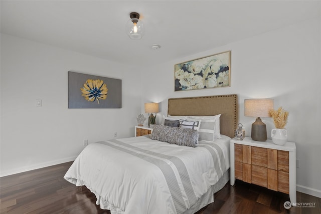 bedroom with dark hardwood / wood-style flooring