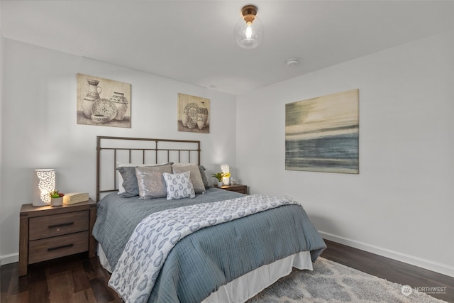 bedroom with dark hardwood / wood-style floors