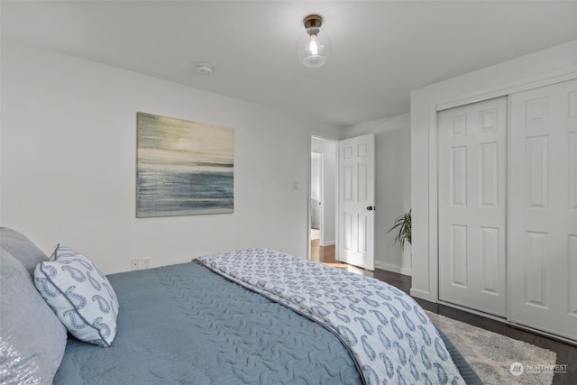 bedroom with a closet and dark hardwood / wood-style flooring