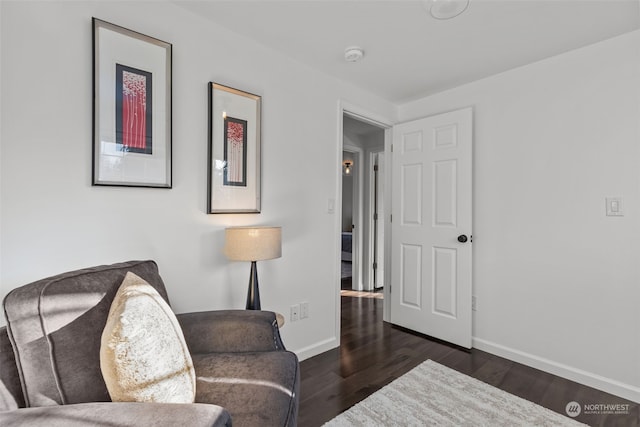 sitting room with dark hardwood / wood-style floors