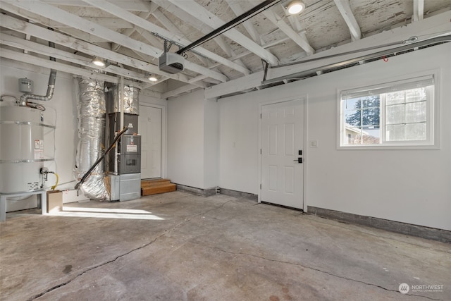 garage featuring heating unit, strapped water heater, and a garage door opener