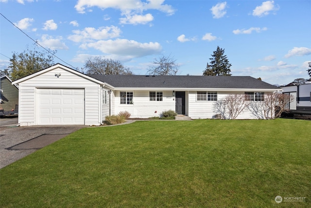 ranch-style home featuring a garage and a front lawn