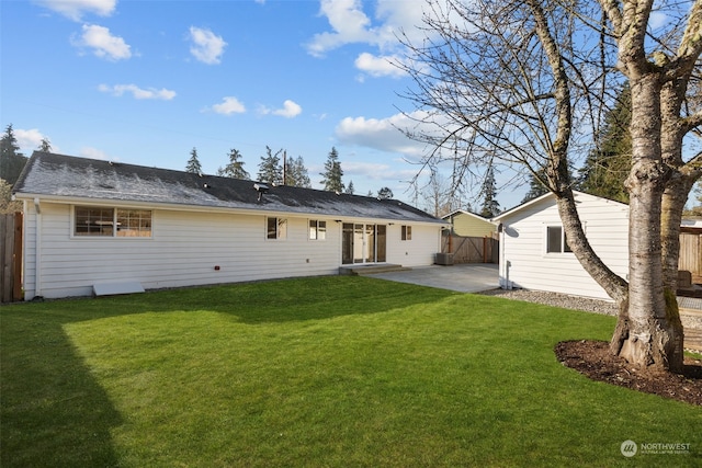 back of property featuring a patio area and a yard