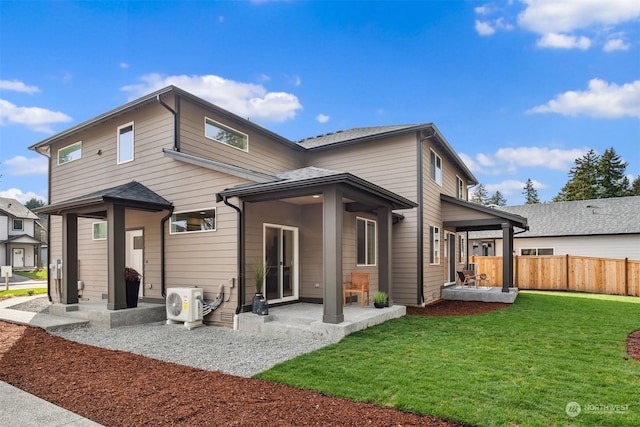 back of house with ac unit, a lawn, and a patio area