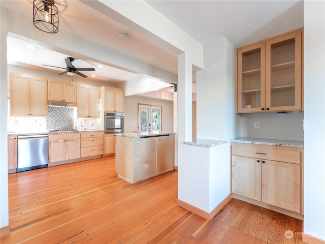 kitchen featuring light hardwood / wood-style floors, light stone counters, appliances with stainless steel finishes, and light brown cabinets