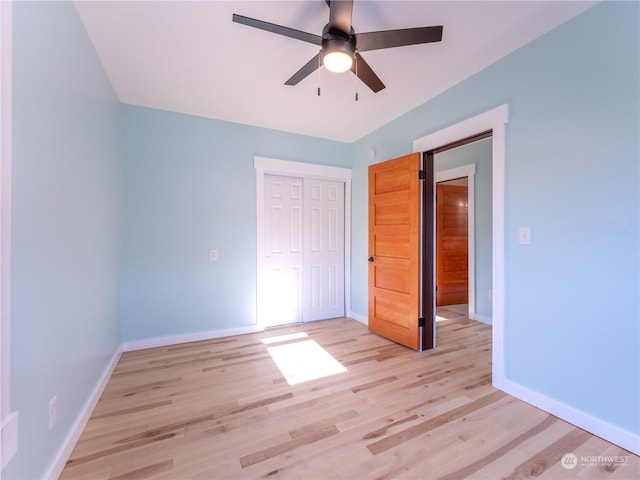 unfurnished bedroom featuring light hardwood / wood-style floors, a closet, and ceiling fan