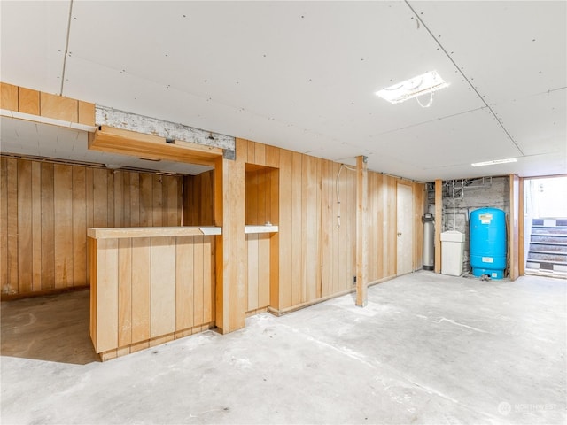 basement with bar and wooden walls