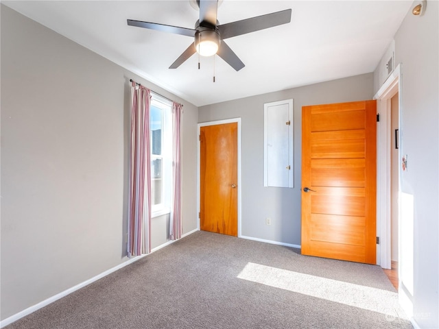 unfurnished bedroom with ceiling fan and light carpet