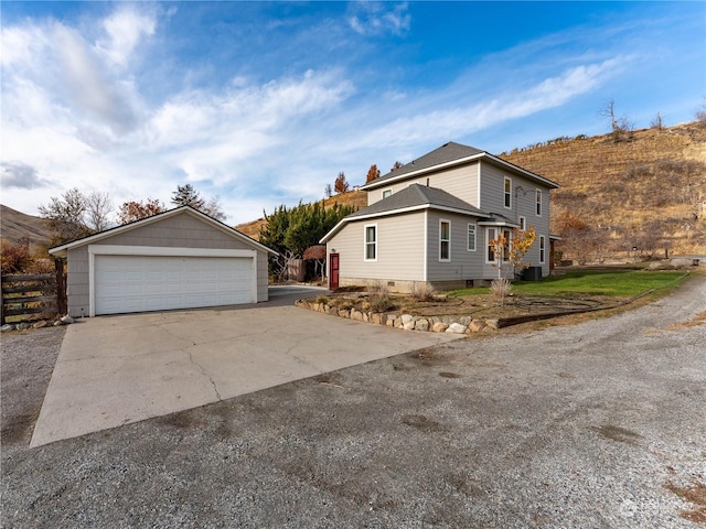 view of property exterior featuring a mountain view and a garage