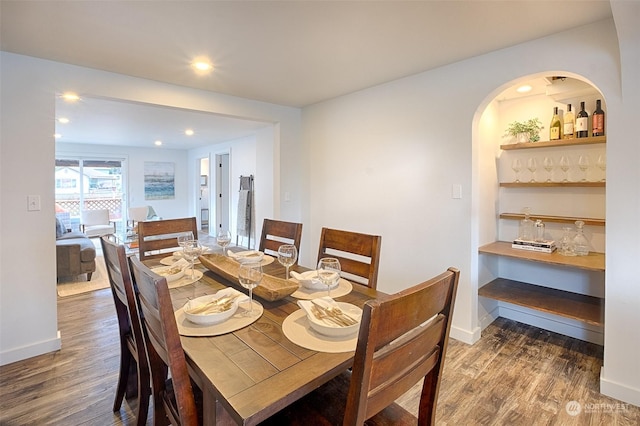 dining space with dark hardwood / wood-style flooring