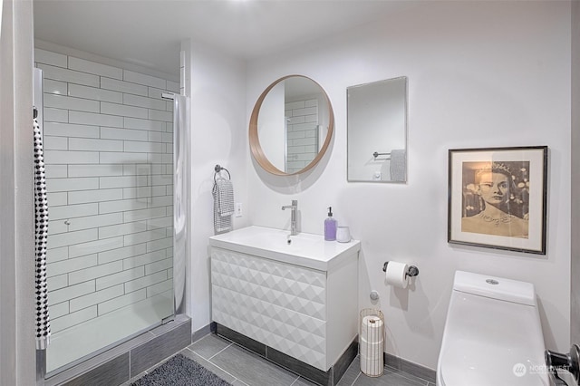 bathroom featuring tiled shower, vanity, toilet, and tile patterned floors