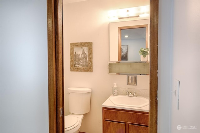 bathroom featuring vanity and toilet