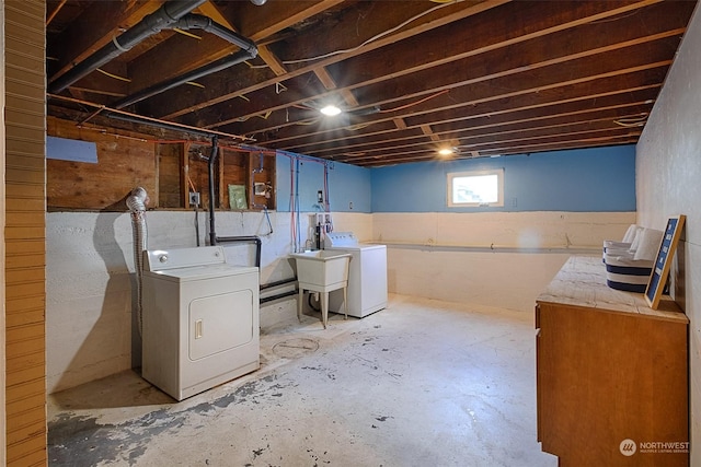 basement featuring sink and independent washer and dryer