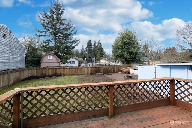 wooden terrace featuring a lawn