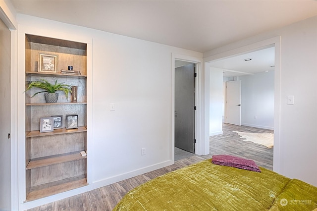 unfurnished bedroom featuring hardwood / wood-style flooring