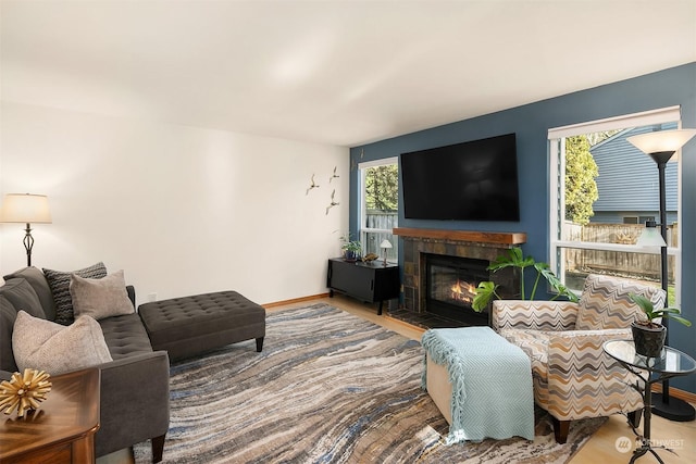 living room featuring plenty of natural light and a tiled fireplace