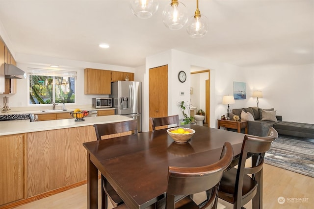 dining room featuring light hardwood / wood-style floors and sink