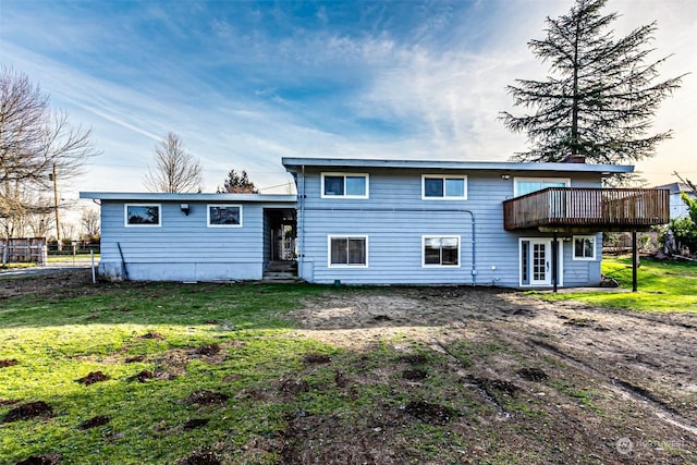 back of property featuring a yard and a deck