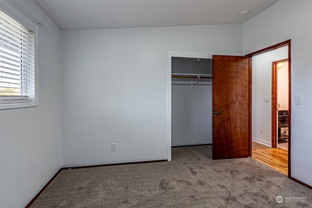 unfurnished bedroom with a closet and carpet flooring