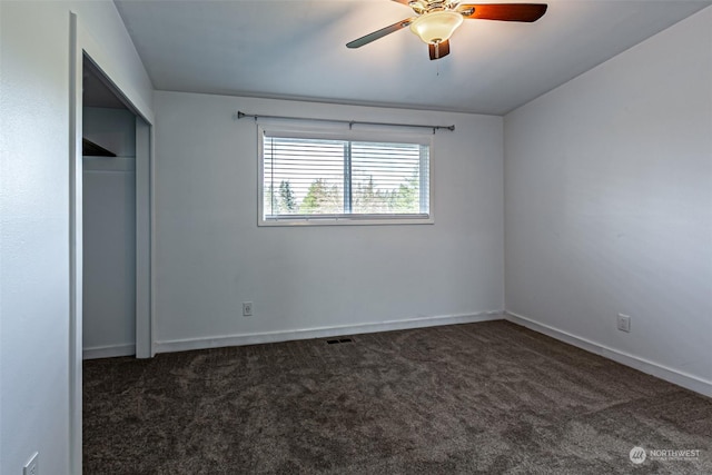 unfurnished bedroom featuring a closet, ceiling fan, and dark carpet