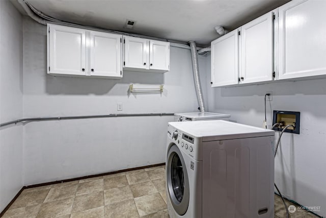 washroom with washer and clothes dryer and cabinets