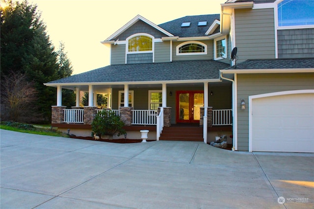 view of front of home with a porch and a garage