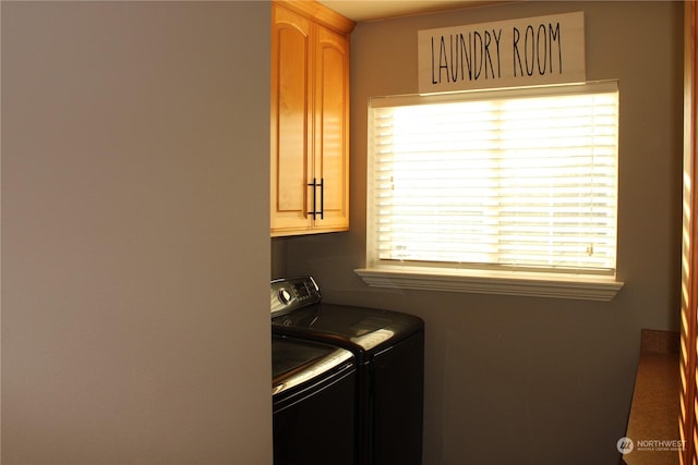 washroom with cabinets and washing machine and dryer