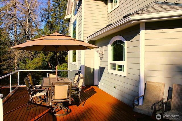 wooden terrace with outdoor dining space