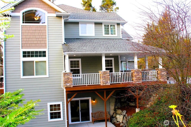 rear view of property with a shingled roof