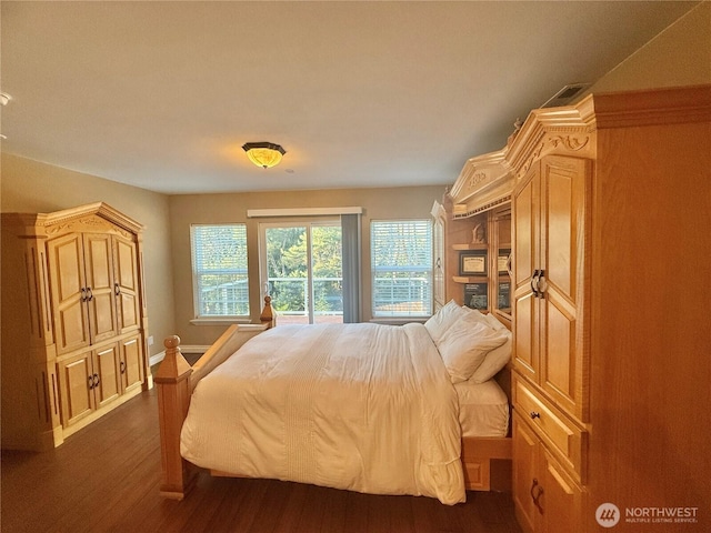 bedroom with visible vents, baseboards, and dark wood-type flooring