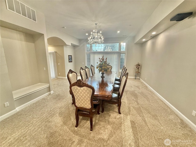 dining space featuring carpet floors, visible vents, and baseboards