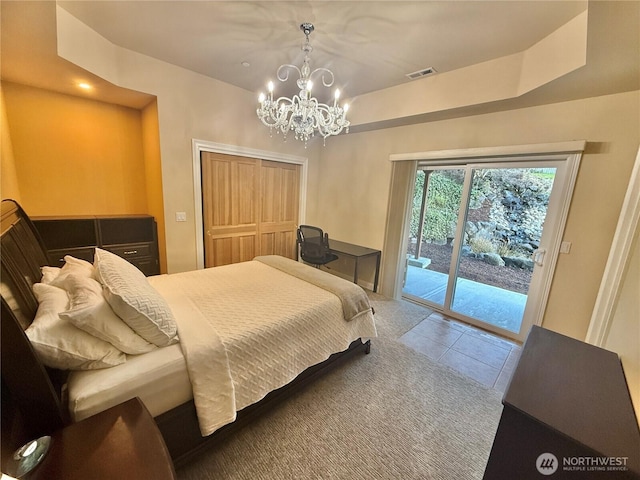 tiled bedroom with access to outside, a closet, visible vents, and an inviting chandelier